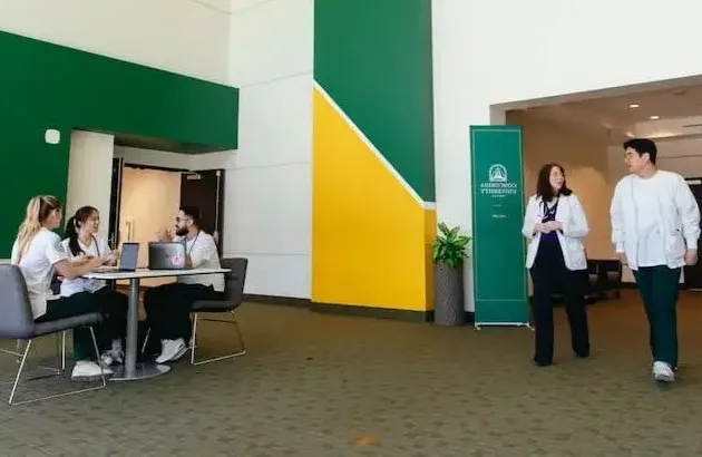 Nursing students and faculty in new building hallway